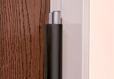 Door safety guard covers door hinges to keep fingers from being pinched